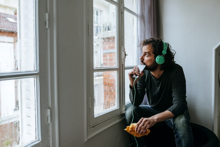 Image: Man Listening to Music with Headphones and Smartphone at Home