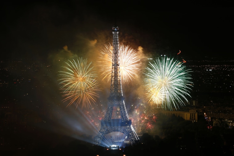 Image: Fireworks light the sky above the Eiffel Tower