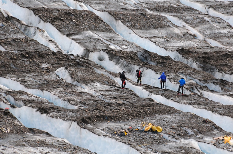 Image: A specialized eight-person recovery team searches for aircraft wreckage