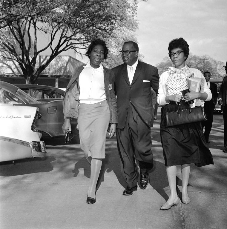 Image: Mary Briscoe (left) and Sandra Ann Jones are escorted by the Rev. T.J. Jemison