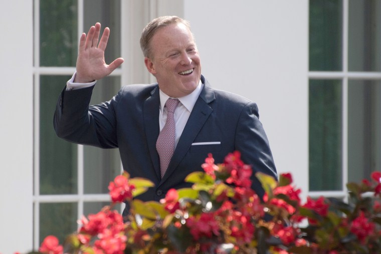 Image: Outgoing White House Press Secretary Sean Spicer smiles as he walks into the West Wing of the White House in Washington, DC, on July 21, 2017.