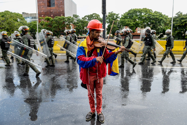 Image: An opposition demonstrator plays the violin during a protest against President Nicolas Maduro in Caracas, on May 24, 2017.