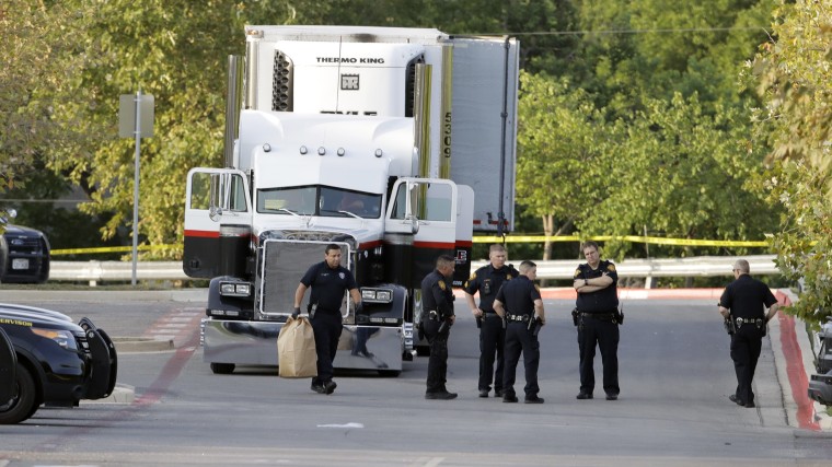 Image: San Antonio police officers investigate the scene where eight people were found dead in a tractor-trailer