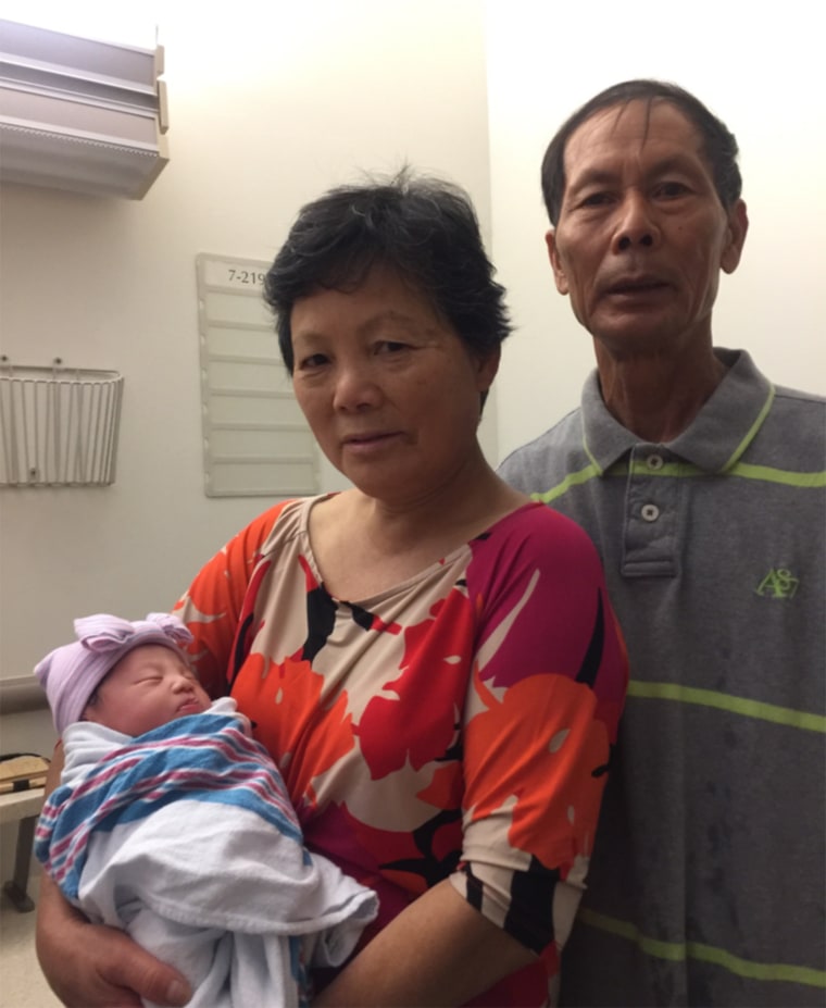 Wei Tang Liu and Xiu Yan Li hold the newborn daughter of their late son, New York Police Det. WenJian Liu. 