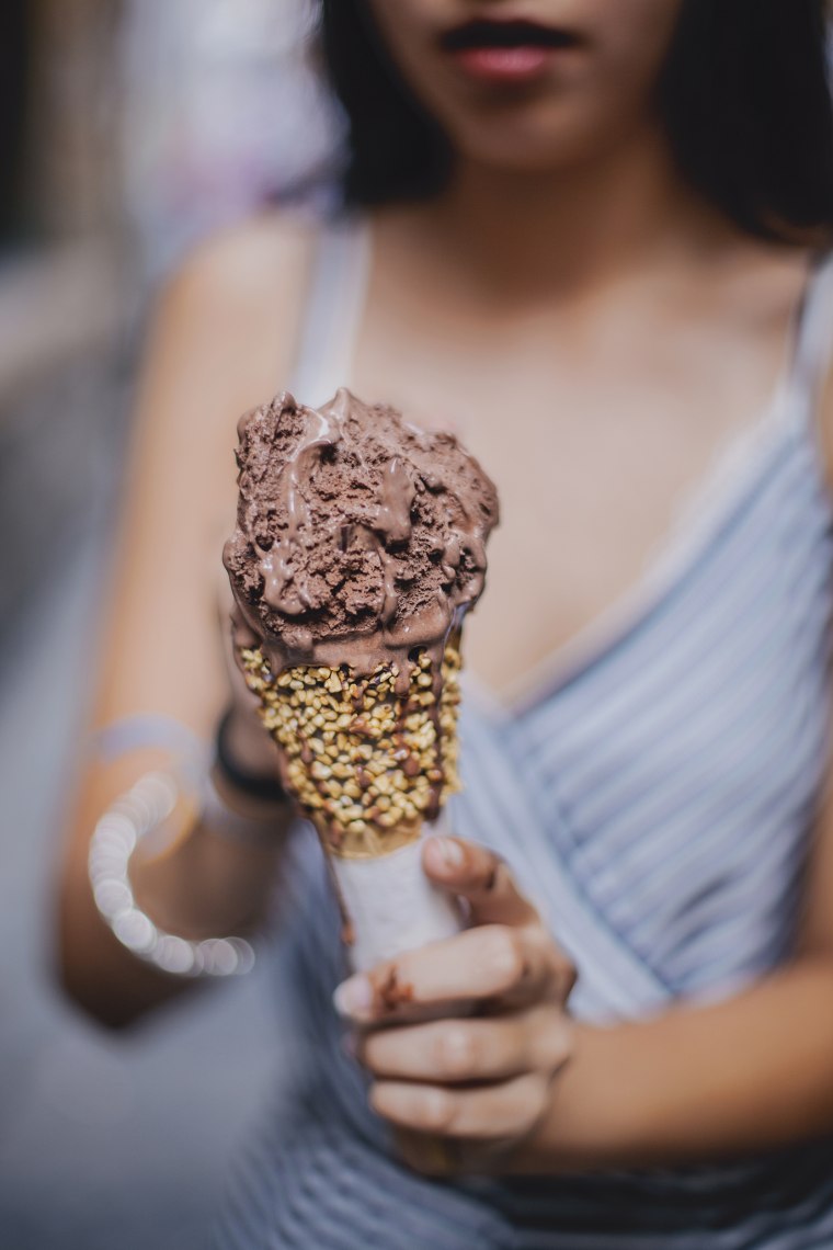 woman holding a chocolate ice cream.