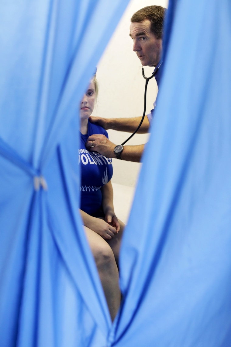 Image: Lt. Governor Ralph Northam gives, Ashton Gardner, from Coborn, Virginia, a neurological examination during Remote Area Medical clinic, July 22, 2017, in Wise, Virgina.