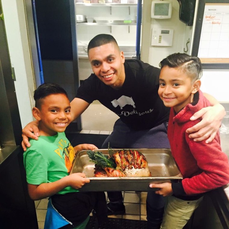 Garcia cooks a bacon wrapped turkey on Thanksgiving with his sons Daniel and Christian.