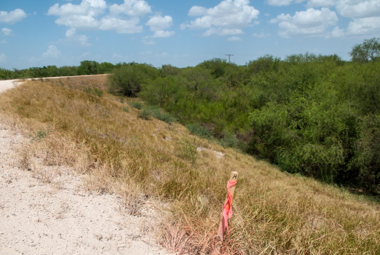 Image: A surveyor stake is seen on the property of the National Butterfly Center in Mission, Texas.