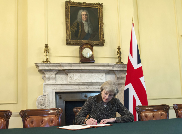 Image: British Prime Minister Theresa May signs a letter setting out the U.K.'s intention to withdraw from the EU