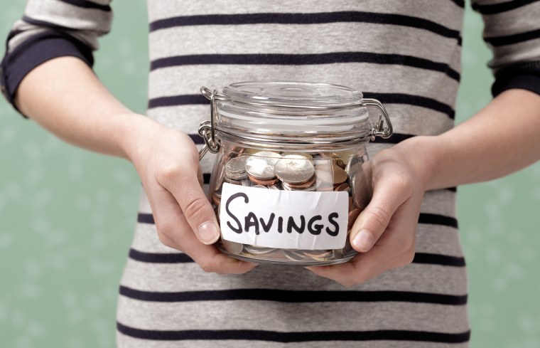 Image: 10 year old holding savings in jar