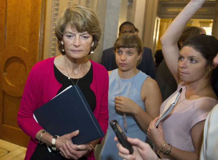 Image: Sen. Lisa Murkowski, R-Alaska., passes reporters as she leaves the Senate Chamber after voting 'no' on a a measure to repeal parts of former President Barack Obama's health care law