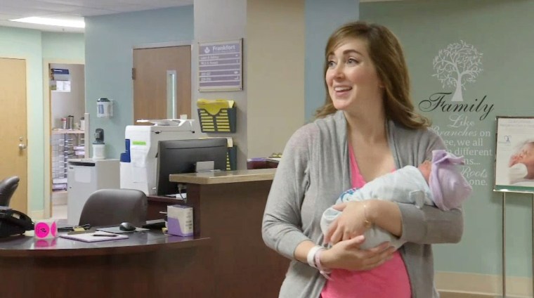 Dr. Amanda Hess holds her newborn baby.