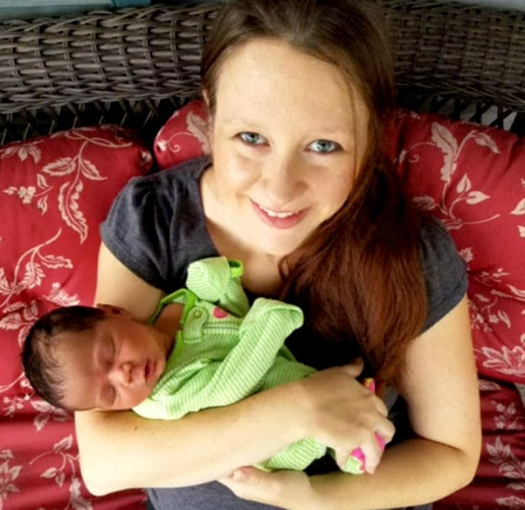 Leah Halliday Johnson holds her newborn baby.