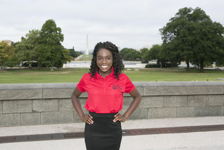 Image: Oti Ogbeide in front of the Washington Monument on Capitol Hill