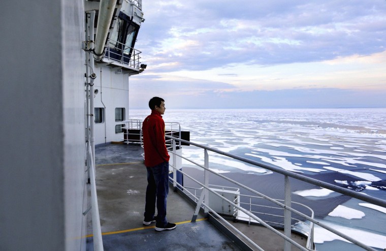 Image: David Kullualik looks over the sea ice of Peel Sound.