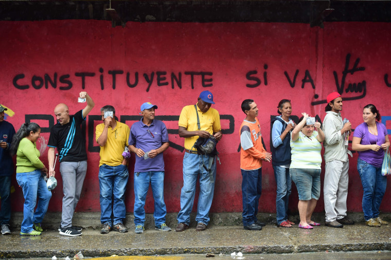 Image: Venezuelans line up to cast their ballot in Caracas.