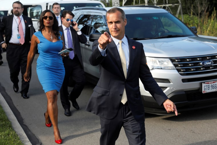 Image: Lewandowski says hello to reporters as he and Gorka, Manigault and Scaramucci accompany Trump for an event celebrating veterans at AMVETS Post 44 in Struthers, Ohio