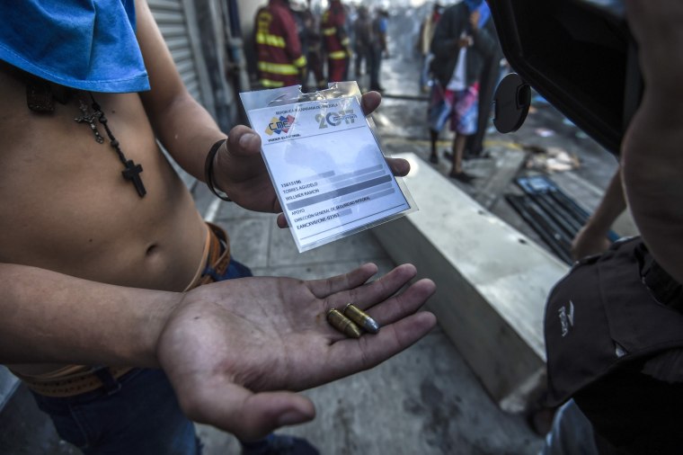 Image: Protester holds bullets