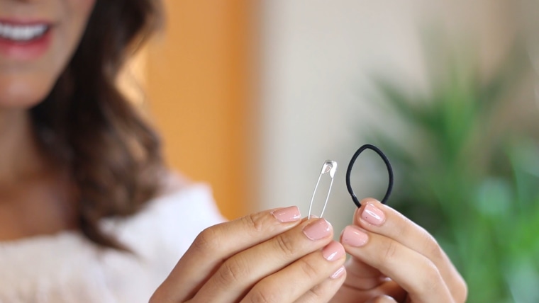 All you need to keep your off-shoulder top in place is a few hair ties and safety pins.