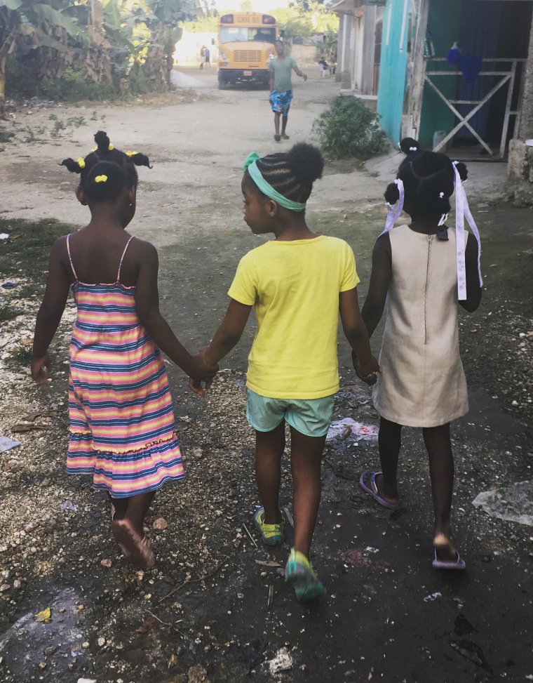 Missy visits with other children from her village during a recent trip to Haiti.