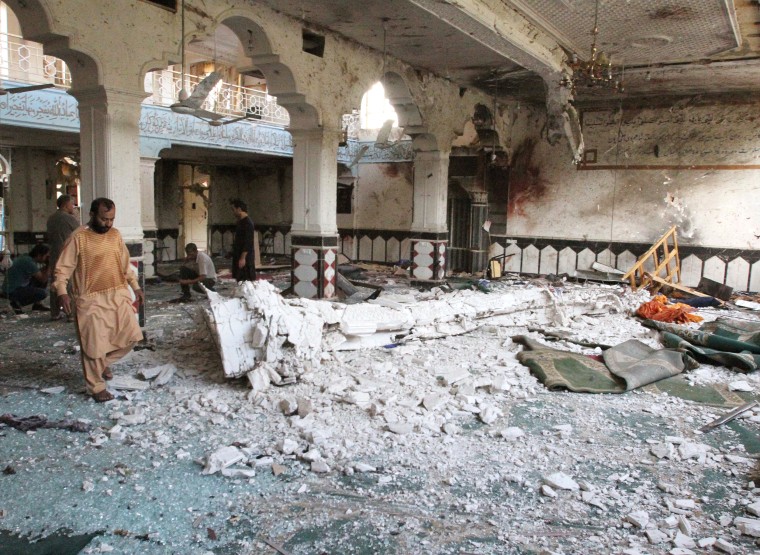 Image: Relatives inspect after an overnight suicide attack at a mosque in Herat