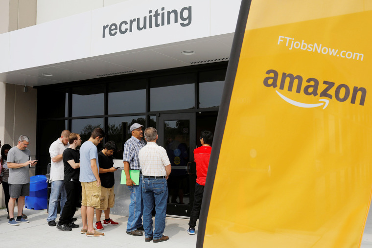 Image: Job seekers line up to apply during "Amazon Jobs Day" at the Amazon.com Fulfillment Center in Fall River