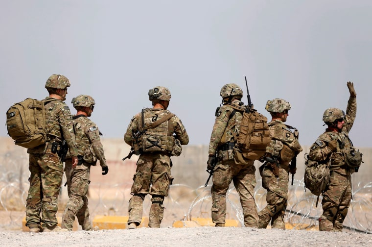 Image: U.S. troops walk outside their base in Uruzgan province