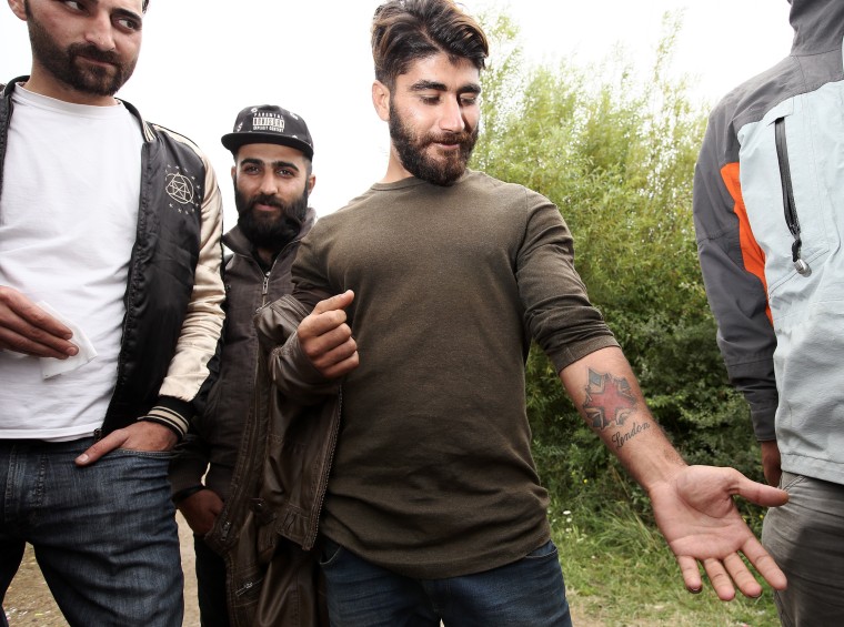 Image: Kurdish migrant Ryan Salah Jabar shows off his "London" tattoo near Dunkirk, northern France.