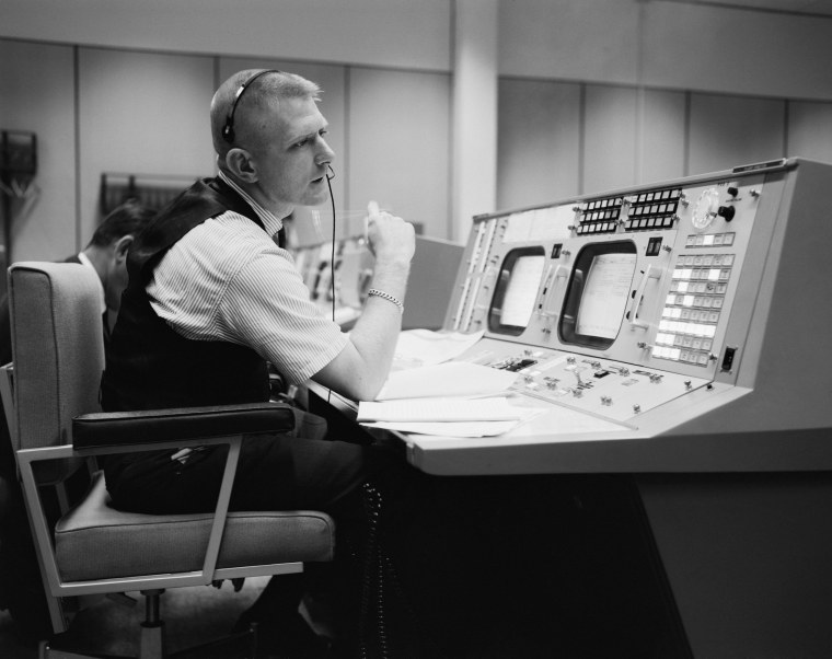 Gene Kranz at his desk in the original mission control room during the Apollo era.