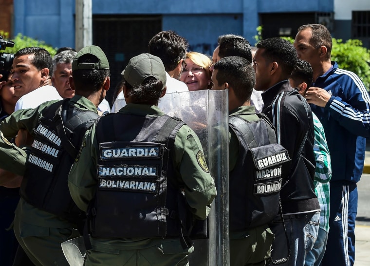 Image: Venezuela's chief prosecutor Luisa Ortega (C), one of President Nicolas Maduro's most vocal critics, is surrounded by people and national guards during a flash visit to the Public Prosecutor's office in Caracas on Aug. 5, 2017.