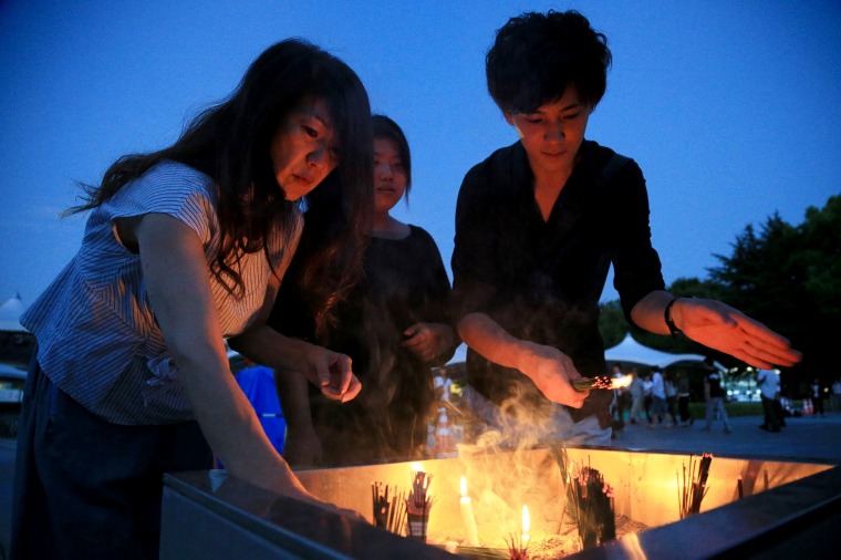 Image: People burn incense and offer prayers early morning prior to the 72nd anniversary memorial service for the atomic bomb victims at the Peace Memorial Park in Hiroshima on Aug. 6, 2017.