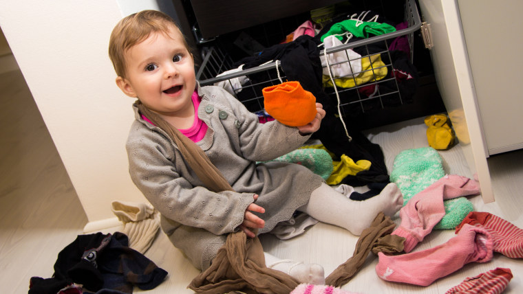 Baby plays in messy clothes