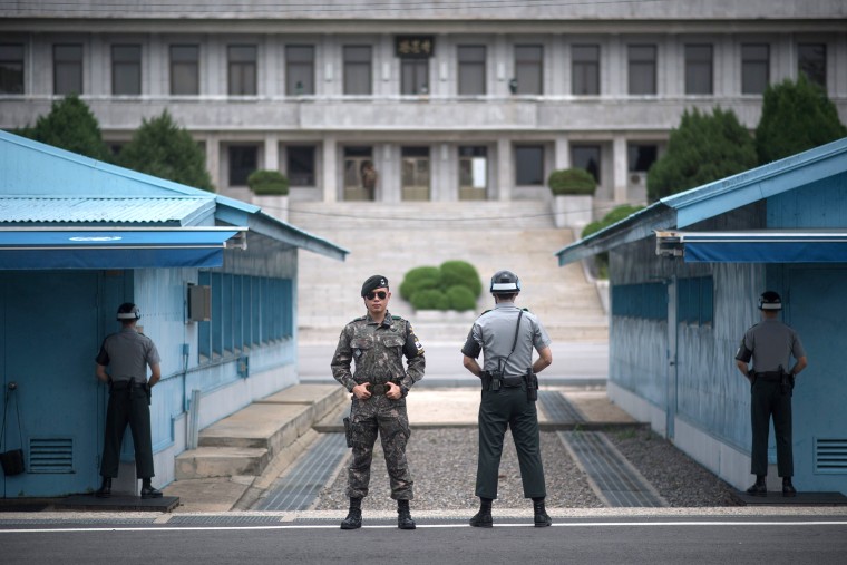 Image: outh Korean soldiers stand guard before North Korea's Panmon Hall