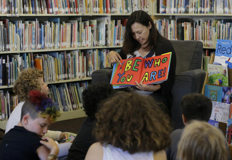 Image: Sandra Collins, executive director and founder of enGender, reads a book to campers at the Bay Area Rainbow Day Camp in El Cerrito, Calif.