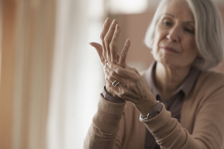 Senior Caucasian woman rubbing her hands