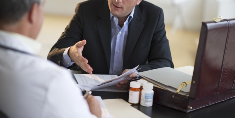 Image: Medical sales representative talking with doctor in office