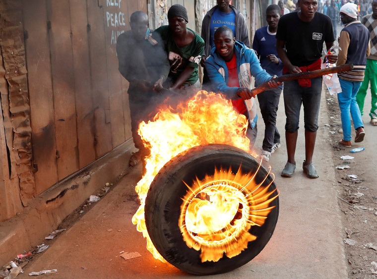 Image: Supporters of opposition leader Raila Odinga set up flaming tyre barricade in Kibera slum in Nairobi