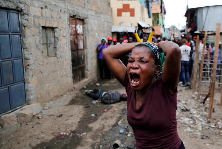 Image: A woman gestures as she mourns the death of a protester in Mathare, in Nairobi
