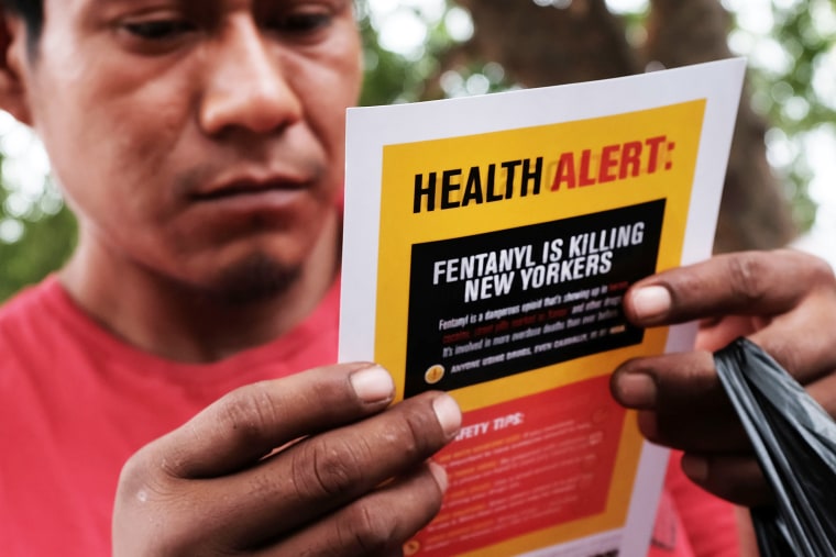Image: A heroin user reads an alert on fentanyl before being interviewed