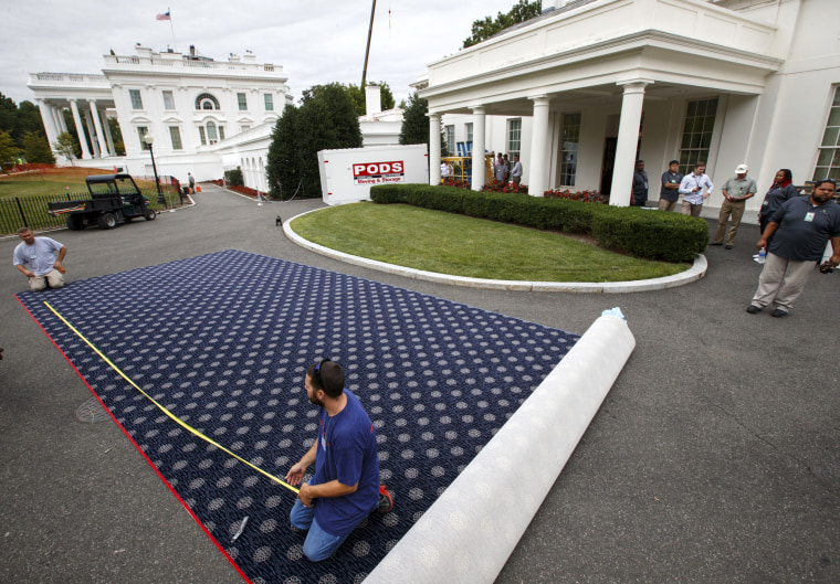 Image: Workmen prepare new carpeting for the West Wing of the White House