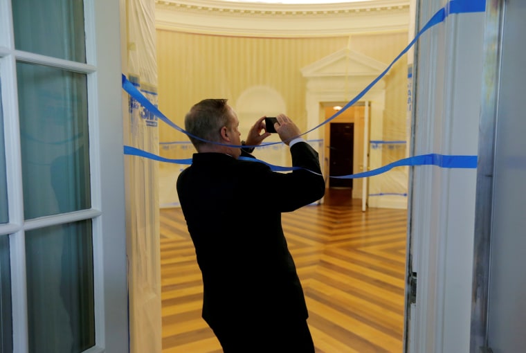 Image: Sean Spicer takes photos of the Oval Office emptied of all furniture