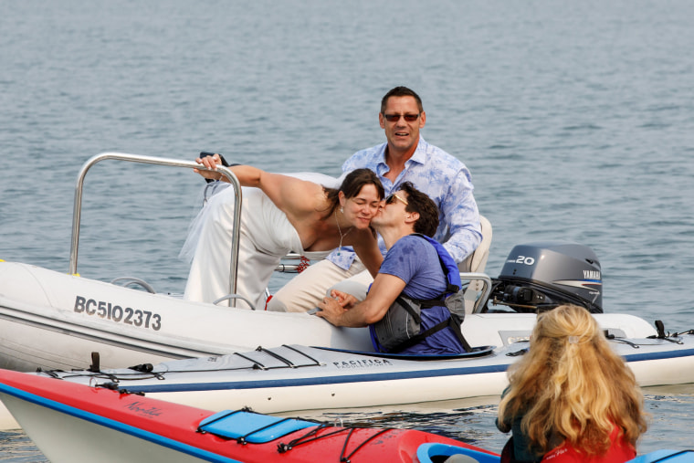 Image: Newlyweds Michelle and Heiner Gruetzner approach Canada's Prime Minister Justin Trudeau while he was kayaking off Sidney