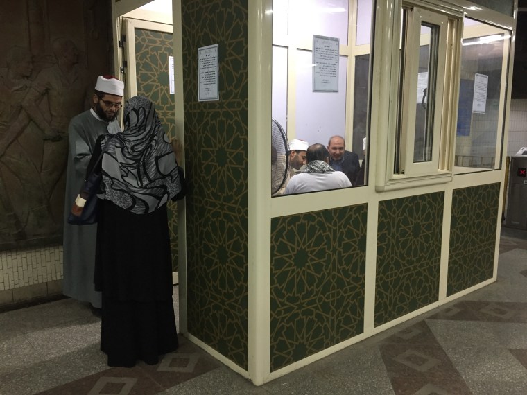 Image: Sheikhs provide theological advice to passengers at the temporary kiosk at Shouhada' subway station in Cairo.