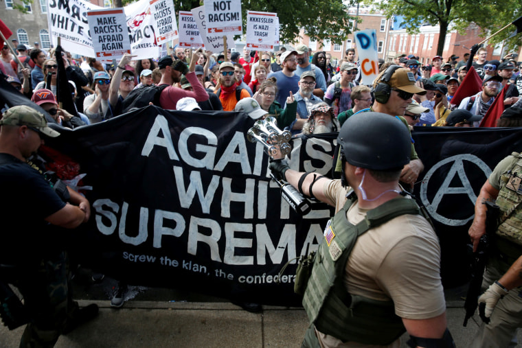 Image: Members of white nationalists are met by a group of counter-protesters in Charlottesville, Virginia, Aug. 12, 2017.