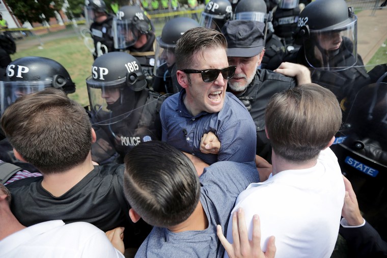 Image: White nationalist Richard Spencer and his supporters clash with Virginia State Police in Lee Park after the \"United the Right\" rally was declared an unlawful gathering Aug. 12, 2017 in Charlottesville, Virginia.