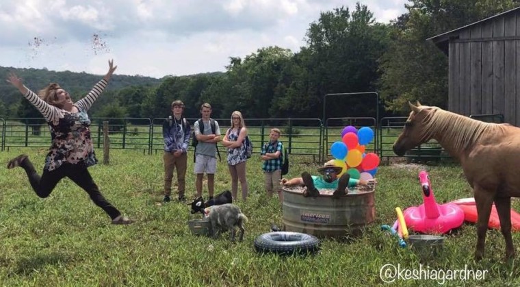 Keshia Gardner with her husband, Andy, their farm animals, and their children.