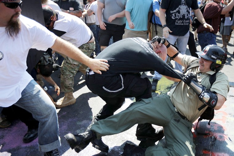 Image: Protesters clash with counter-protesters as they enter Lee Park during the "Unite the Right" rally in Charlottesville