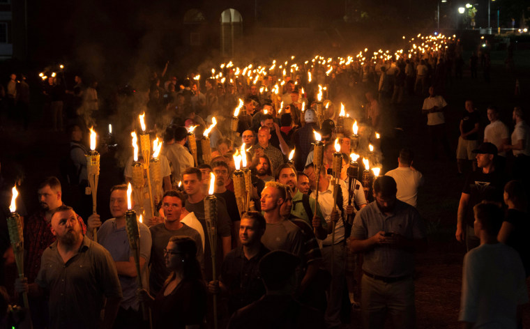 Image: White nationalists carry torches on the grounds of the University of Virginia, on the eve of a planned Unite The Right rally in Charlottesville