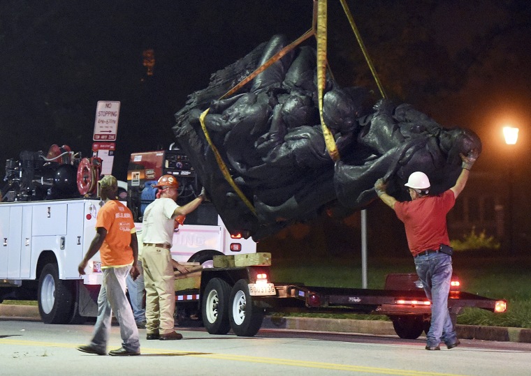 Image: Workers remove a monument dedicated to the Confederate Women of Maryland