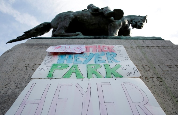Image: A sign on the statue of Robert E. Lee calls for the park to be renamed for Heather Heyer, who was killed at in a far-right rally, in Charlottesville, Virginia